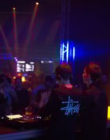 a dj spinning around in a nightclub