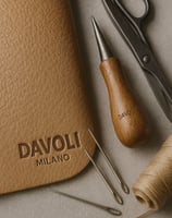 a leather case with a pair of scissors and a pair of scissors