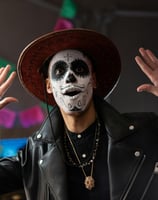 a man in a black leather jacket and a white face paint on his face