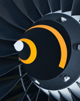 Close-up view of an airplane turbine engine, showcasing the intricate metal blades within the engine