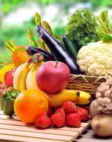 a basket of fruits and vegetables on a table