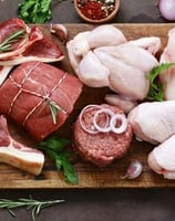 a cutting board with meat and vegetables on it