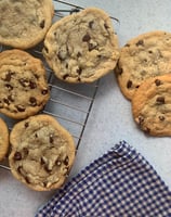 freshly baked sugar cookies displayed before a farmers market selling assorted baked goods