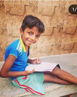 young boy doing home study