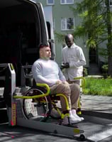 a man in a wheelchair patient transportation services
