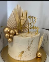 a cake with a gold birthday cake topper