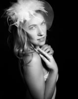 a woman in a hat with a feathered hat