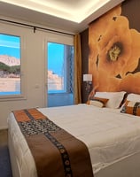 a bedroom with a large bed and a television