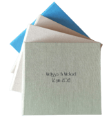a stack of three different colored envelopes