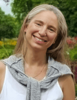 a woman in a white tank top and a gray scarf cecilia aylion