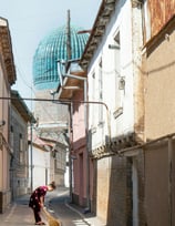 A girl is sweeping a narrow street in Tashkent