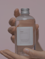 a person holding a bottle of water in their hand