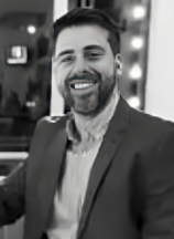 a man in a suit and tie smiling at the camera alejandro lange
