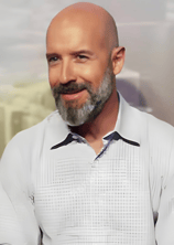 a bald balding man with a beard and a white shirt martin pe coach