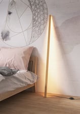 a bed with a lamp and a lamp on the side of the bed
