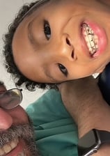 a man and a child are smiling and posing for a picture