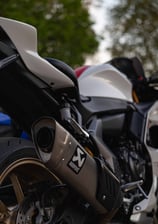 a motorcycle parked next to a parked car