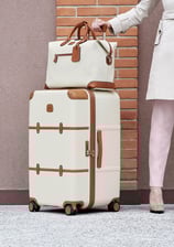a woman in a white coat with a travel luggage and travel bags