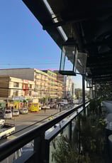 a view of a city street with cars parked on the side of the street