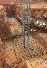 a construction worker is working on a steel structure