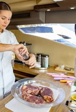 a woman in a white shirt is preparing to cook