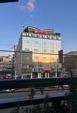 a building with a large glass building in the background