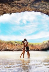 a couple kissing in a cave Marietas