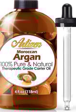 a bottle of argan oil with a glass bottle of argan oil