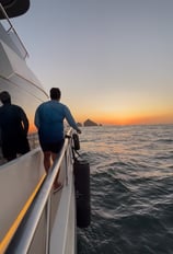 a man standing on a boat in the ocean