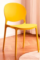 3D Renders of modern plastic chair set in a cozy, bright room with a wooden table, soft tones