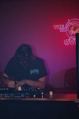 a man in a black shirt is playing a dj - creechur