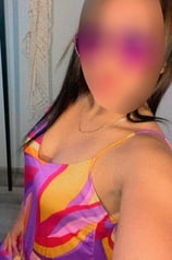 a woman with a large breast breast, wearing a colorful dress