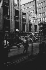 a worker walking down a street in a city
