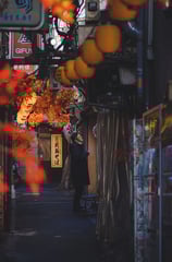 Elvin Mendoza captures the vibrant, bustling streets of Shinjuku, Tokyo where a man is smoking.