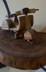 a wooden scooter Vespa sitting on a wooden table at the sunrise lodge and lounge museum bali lovina
