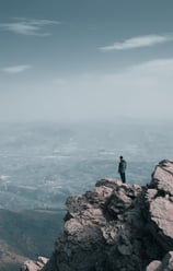 a person standing on a mountain top