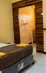 a bedroom with a bed and a mirror our happy and confortable room at sunrise lodge and lounge lovina 
