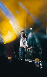 a man standing on a stage with a microphone and a microphone, festival de jazz, montreal
