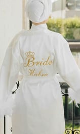 a bridesmaid wearing a white robe