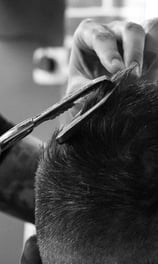 a man is cutting his hair with scissors and scissors
