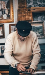a man in a hat and a hat on a table