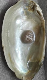 "11mm white divine designer pearl–side angle showing sacred face design and luster-for export"