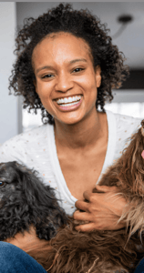 Young african american woman with two older dogs
