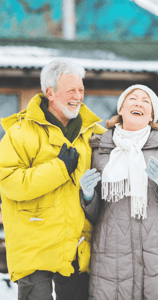 Laughing older couple outside in winter