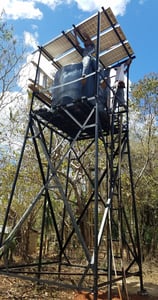 Solar PV modules over top of a water tank on a steel tower