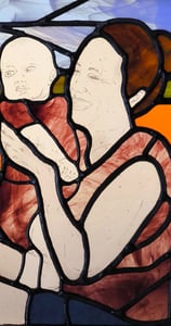 a painting of a woman holding a baby in a stained glass window