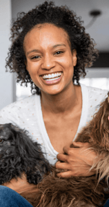Young african american woman with two older dogs