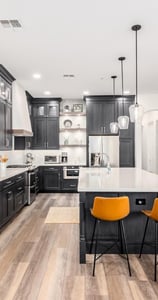 "Custom kitchen design with white quartz countertops, wood accents, and stainless steel finishes"