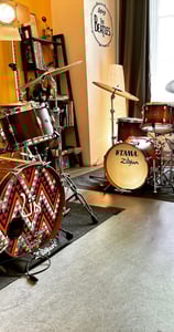 a drum kit with drums and drums in a room
