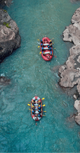 a group of people rafting down a river
